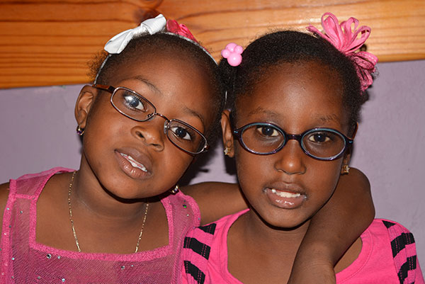 two young girls wearing glasses