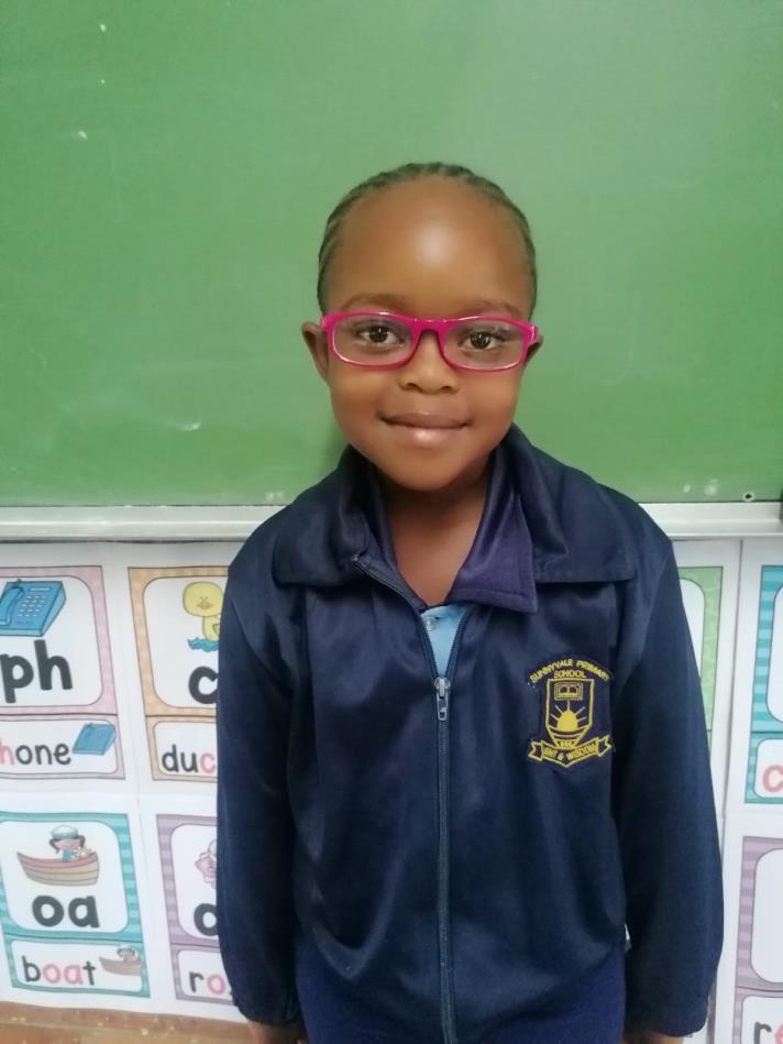 Photo of 7 year old Syamthanda from South Africa wearing the glasses she was given.