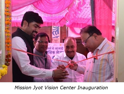 Mission Jyot Vision Centre_Inauguration with caption A photo of Mission Jyot Vision Centre Inauguration ceremony showing four people smiling and cutting a ribbon across the door of the vision center.